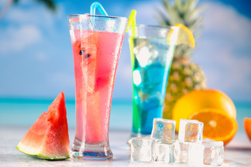 Set of exotic drinks on the beach with blue ocean background