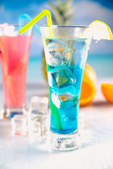 Set of exotic drinks on the beach with blue ocean background