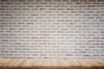 Mock up wooden table with rustic brick wall. For product display montage.