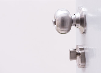 white door with metal doorknob is regular lock style in a house.