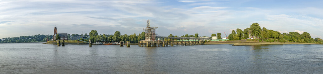 Obraz premium view to entrance of harbor of Hamburg and historic radar station and petrol filling station