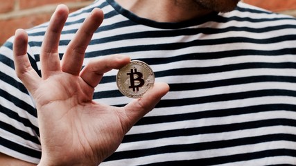 Bitcoin in man hand