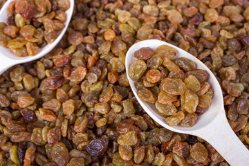 Raisins in a wooden spoon, close-up, food background