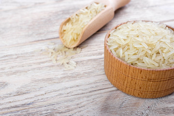 Jasmine rice in a bowl on wooden background