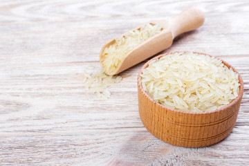 A wooden bowl of long grain white rice