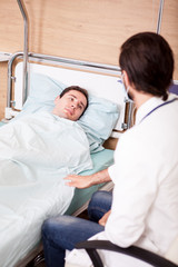 Fototapeta premium Doctor with patient in recovery room. Modern medicine and healthcare