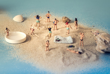 miniature people at the beach having fun 