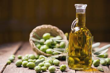 Olive oil and olives on wooden rustic table