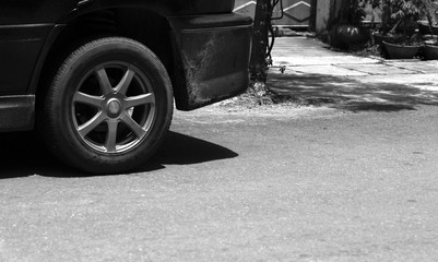 Fototapeta na wymiar BLACK AND WHITE PHOTO OF CAR TYRE AND ALUMINIUM WHEEL RIM