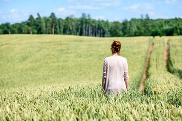 Naklejka na ściany i meble woman in Wheat Field enjoying silence