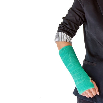 Closeup of a broken arm in a cast isolated on white background