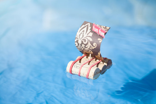 Paper boat with wine cork floating on the sea. Concept, fun, handmade