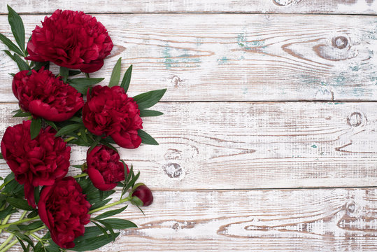 Fototapeta Red Peonies flowers on the white wooden table