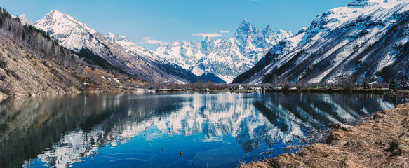 Lake and high mountains in clear weather, traveling and hiking.