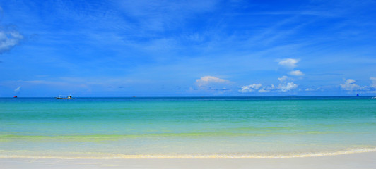 Pristine white beach, sea & blue sky meeting in horizon