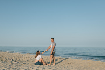 The loving couple holds hands at the sea