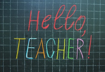 The word " teacher" written on the blackboard