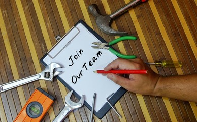 Construction work job concept. Notepad and various tools with word join our team