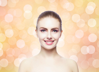 Naklejka premium Portrait of young, beautiful and healthy woman: over warm orange background. Healthcare, spa, makeup and face lifting concept.