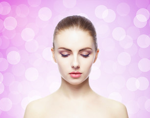 Portrait of young, beautiful and healthy woman: over pink background. Healthcare, spa, makeup and face lifting concept.