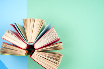 Top view of bright colorful hardback books in a circle.