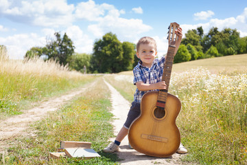 Beautiful little boy with guitar