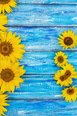 Autumn background with sunflowers on wooden board. Yellow fresh sunflowers on rustic wooden table background