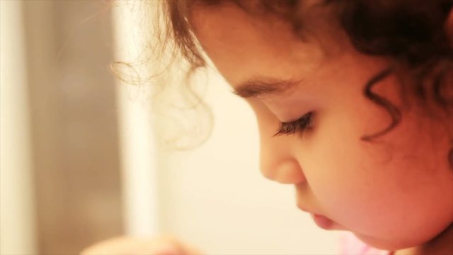 Face Closeup. Little Prety Baby Girl Watching Cartoons on Tablet.mov