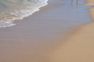 Soft wave of the sea in the corner of sandy beach texture, clear sandy beach natural background