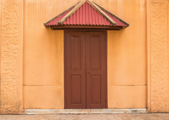 The entrance to the house here is surrounded by orange walls.