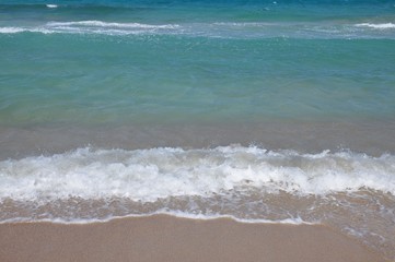 Sea ocean water waves on sanfy beach natural photo