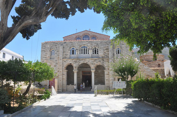 Church of Panagia Ekatontapiliani in Parikia, typical front entrance view with tree branches in...
