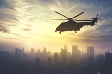 Army helicopter flying at sunrise time