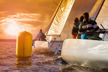 Sailing yacht race, regatta.Sailboat at sunset. Recreational Water Sports, Extreme Sport Action. Healthy Active Lifestyle. Summer Fun Adventure. Hobby