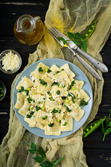 Ravioli with ricotta and young green peas. Flat lay. Top view