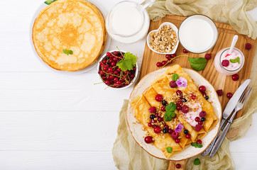 Pancakes with yoghurt, honey, nuts and summer berries. Tasty breakfast. Flat lay. Top view