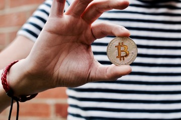 Bitcoin in man hand