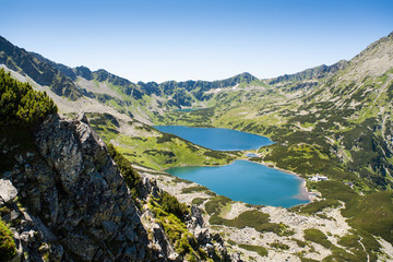 Fototapeta na wymiar Tatras mountains, Valley of five ponds. View on mountains and two lakes. Trail to see eye from the mountain hostel in five ponds. Five breathtaking mountain lakes in the High Tatras.