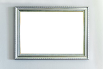 The blank ornate picture frame on the wall