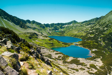 Naklejka na ściany i meble Tatras mountains, Valley of five ponds. View on mountains and two lakes. Trail to see eye from the mountain hostel in five ponds. Five breathtaking mountain lakes in the High Tatras.