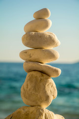 White Stone stacked together on blue background