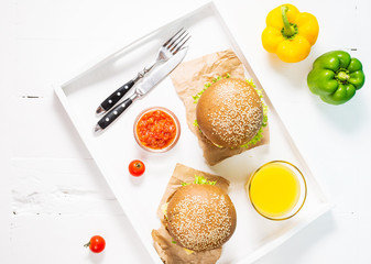 Fresh homemade burgers with juice served on white tray