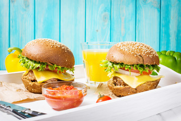 Fresh homemade burgers with juice served on white tray