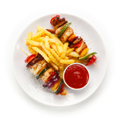 Kebabs - grilled meat and vegetables on white background 