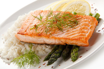 Grilled salmon with french fries on cutting board 