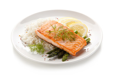 Grilled salmon with french fries on cutting board 