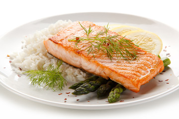 Grilled salmon with french fries on cutting board 