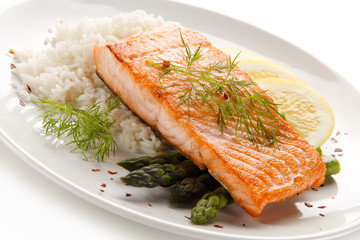 Grilled salmon with french fries on cutting board 