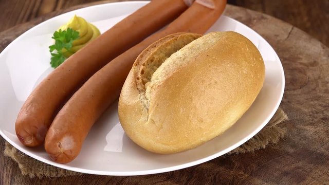 Wiener Sausage on a rotating wooden plate as seamless loopable 4K footage