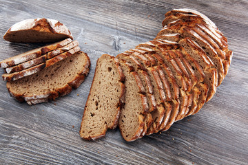 freshly baked bread on wooden board. cutted bread